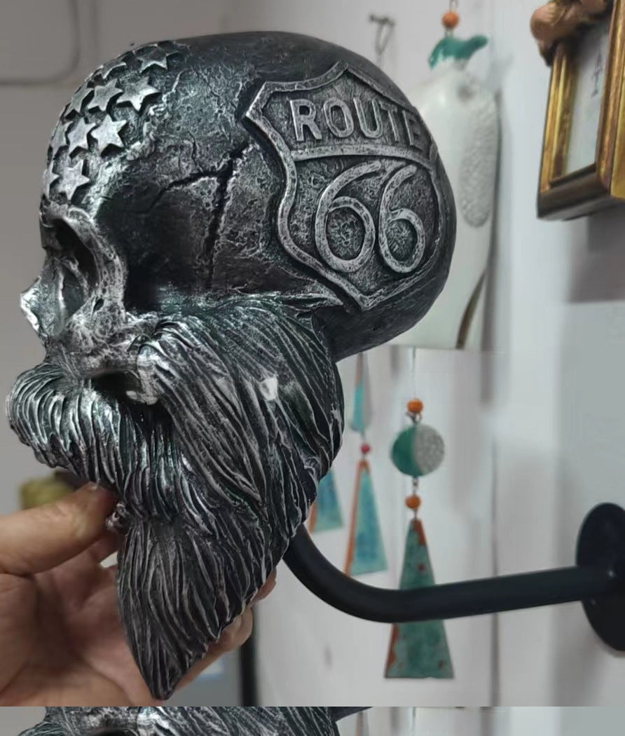 Decorative helmet holder with skull made of synthetic resin